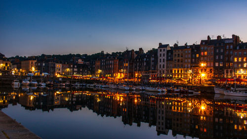 Reflection of illuminated buildings in city at night