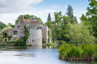 Castle by trees against sky