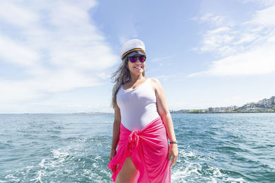 A woman on top of a boat against the sea in the background. salvador, bahia, brazil.