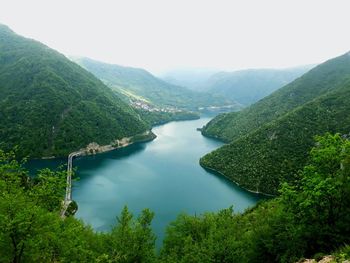 High angle view of river amidst trees against sky