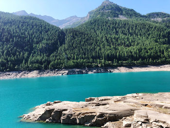 Scenic view of sea and mountains against sky