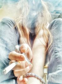 Low angle view of woman smoking cigarette
