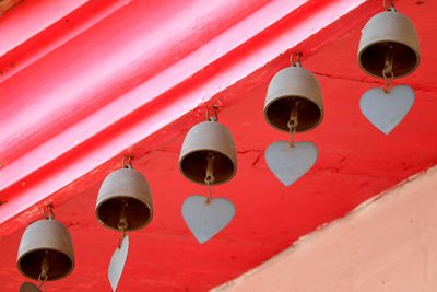 Low angle view of lanterns hanging by building