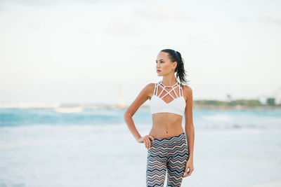 Young woman standing at beach