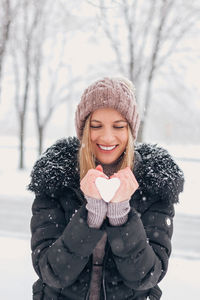 Portrait of a smiling young woman in snow