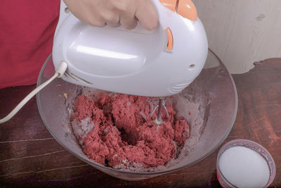 Cropped image of person mixing ingredients in bowl