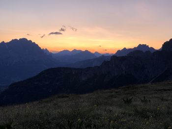 Scenic view of silhouette mountains against sky at sunset