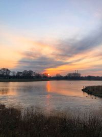 Scenic view of lake against sky during sunset