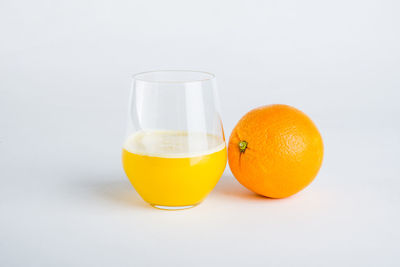 Orange fruit against white background