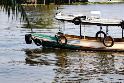 Side view of boat moored in lake