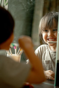 The boy brushes his teeth with a toothbrush made of ecological material