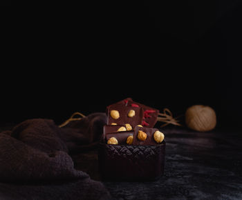 Close-up of cookies on table against black background