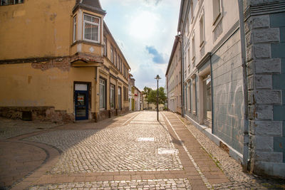 Empty alley amidst buildings in town