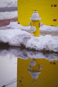 Close-up of yellow umbrella on snow