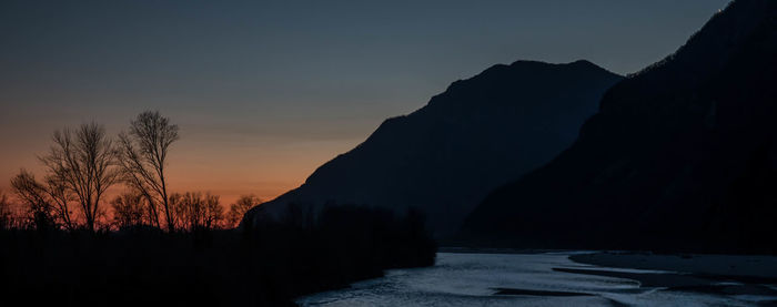 Scenic view of silhouette mountains against sky during sunset