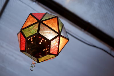 Low angle view of illuminated lantern hanging on ceiling