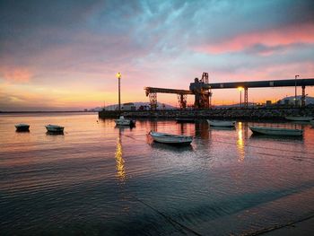 Pier over sea against sky during sunset