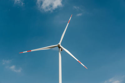 Low angle view of windmill against sky