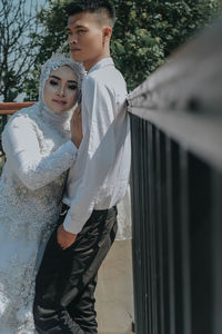 Portrait of young couple standing outdoors