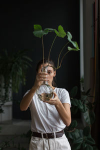 Full length of woman standing against plants