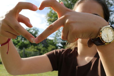 Close-up of hand holding heart against blurred background