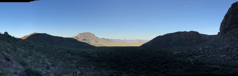 Scenic view of mountains against clear blue sky