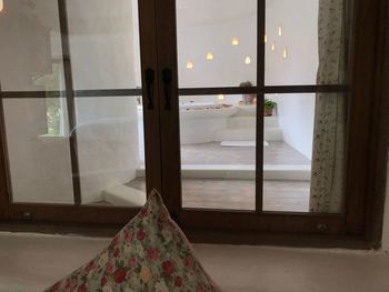 View of bed through window at home