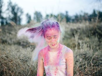 Young woman standing on field