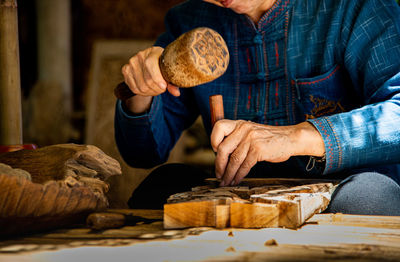 Midsection of man preparing food at store