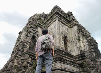 Low angle view of man looking at temple