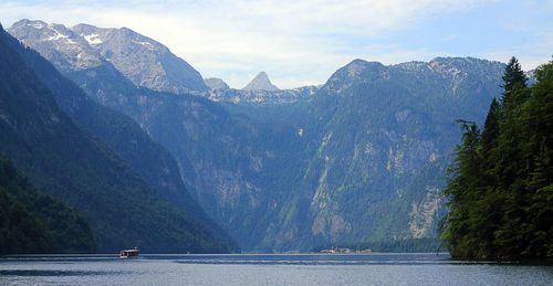 Scenic view of lake and mountains against sky