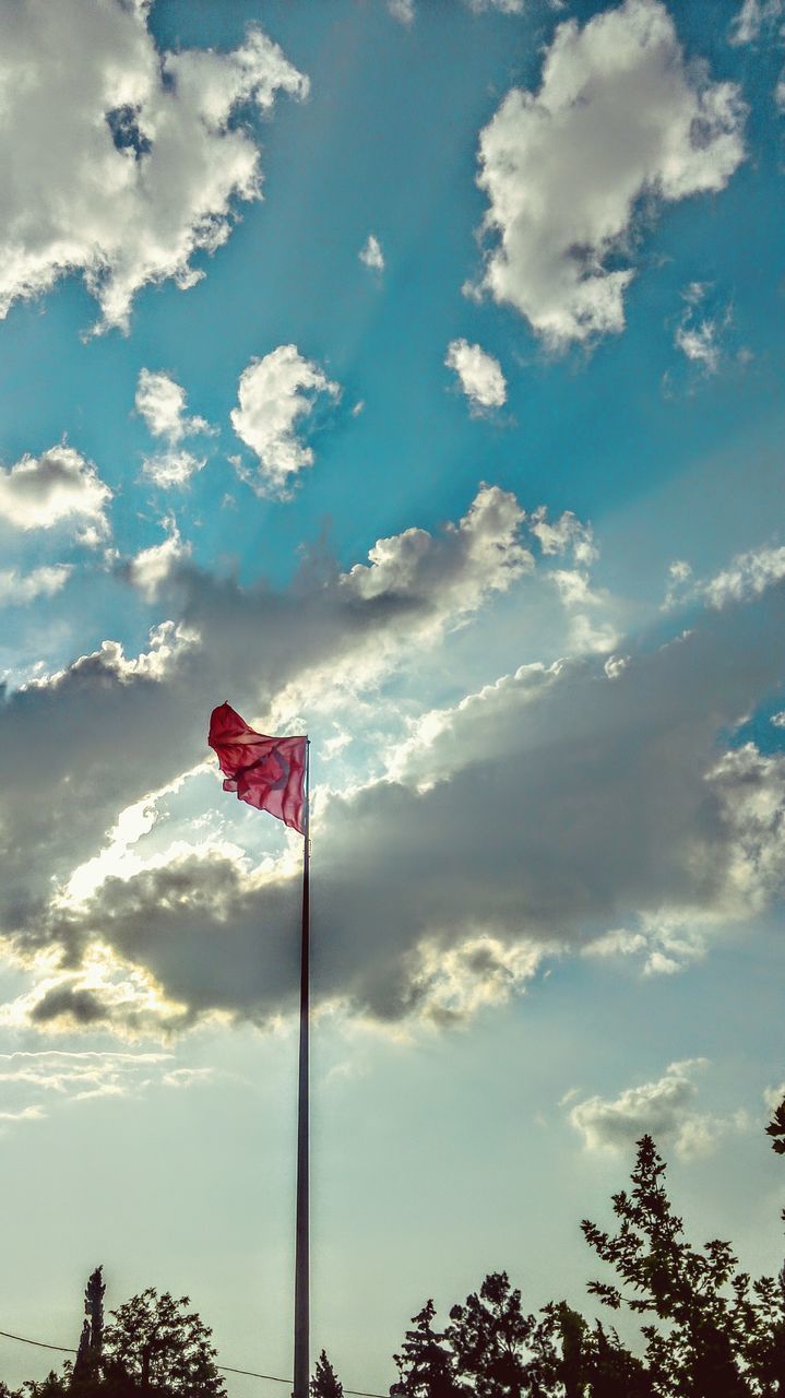 low angle view, sky, cloud - sky, flag, cloud, pole, patriotism, identity, blue, national flag, cloudy, red, day, american flag, protection, outdoors, wind, safety, nature, no people