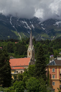 Traditional building by mountains against sky