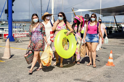 Women walking in bikini with beach accessories. salvador, bahia, brazil.