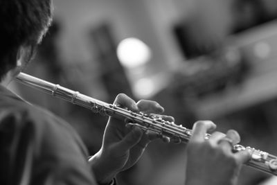 Close-up of man playing flute