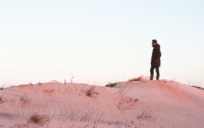 Full length rear view of man standing in desert