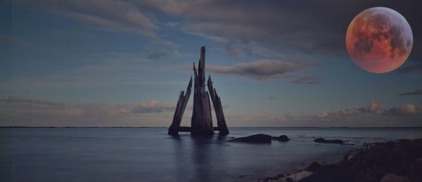 Scenic view of sea against sky at sunset