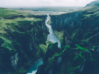 Scenic view of river amidst mountains