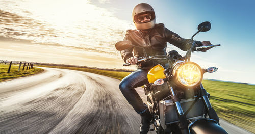 Low angle view of man riding motorbike