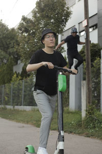 Full length of young woman standing on road