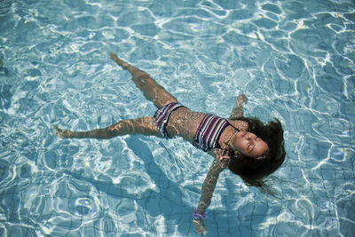 High angle view of woman swimming in pool