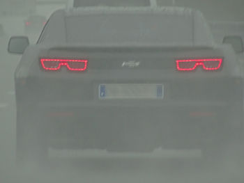 Close-up of illuminated text on car windshield