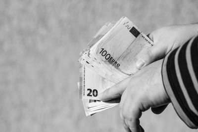 Cropped hand holding paper currency