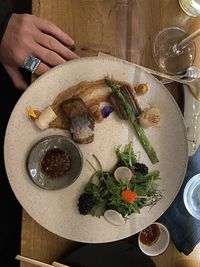 High angle view of hand holding food on table