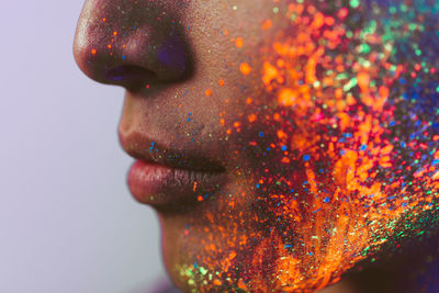 Close-up of man with multi colored face paint