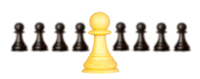 Close-up of chess pieces against white background