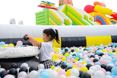 Portrait of boy playing with balloons