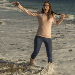 Full length of young woman at beach