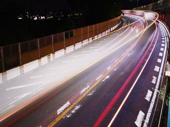 High angle view of light trails on road at night