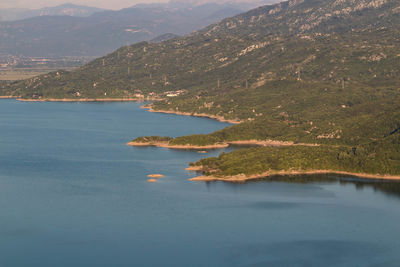 Scenic view of sea and mountains against sky